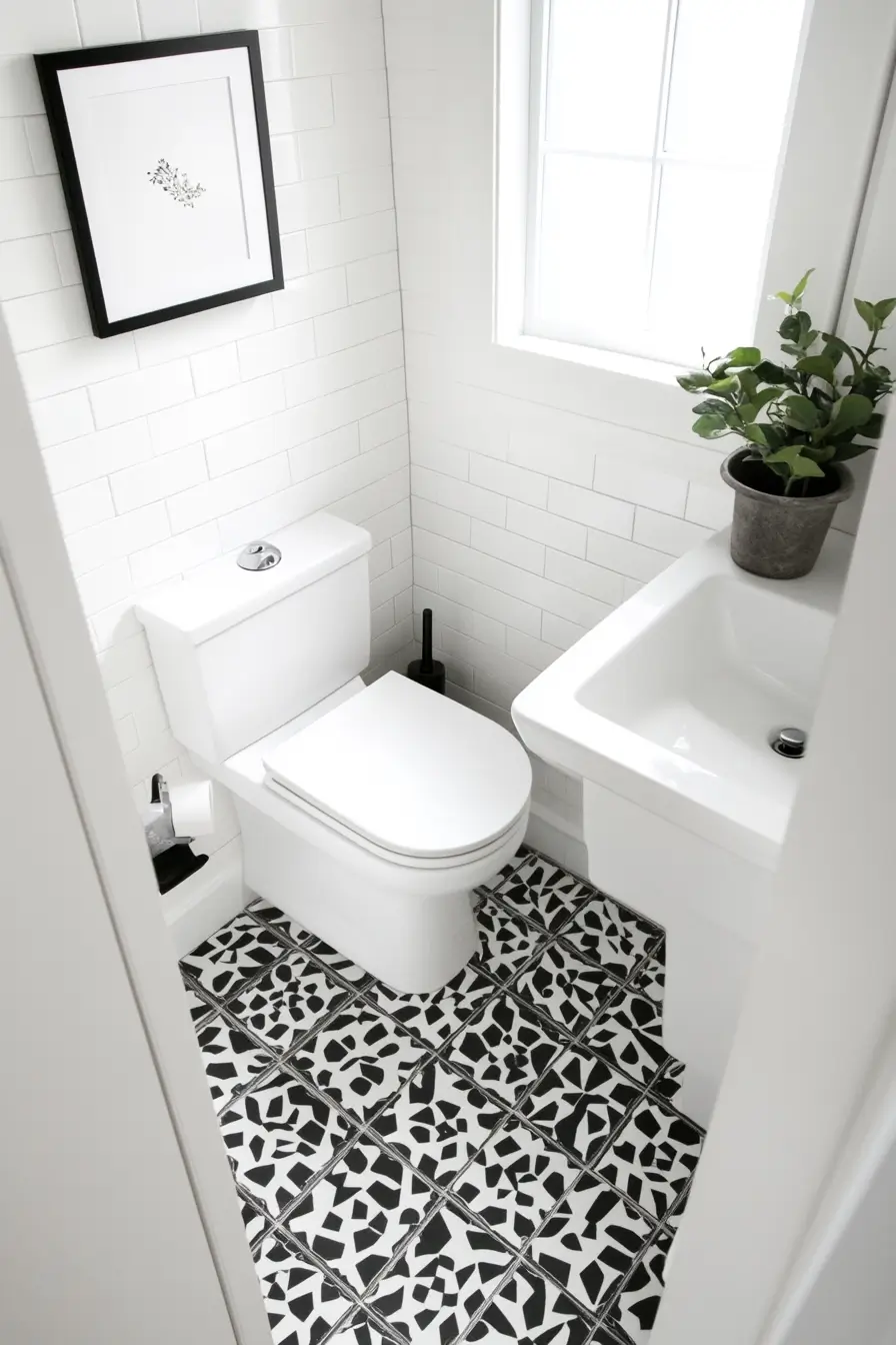 Small bathroom with striking geometric patterned floor tiles in black and white
