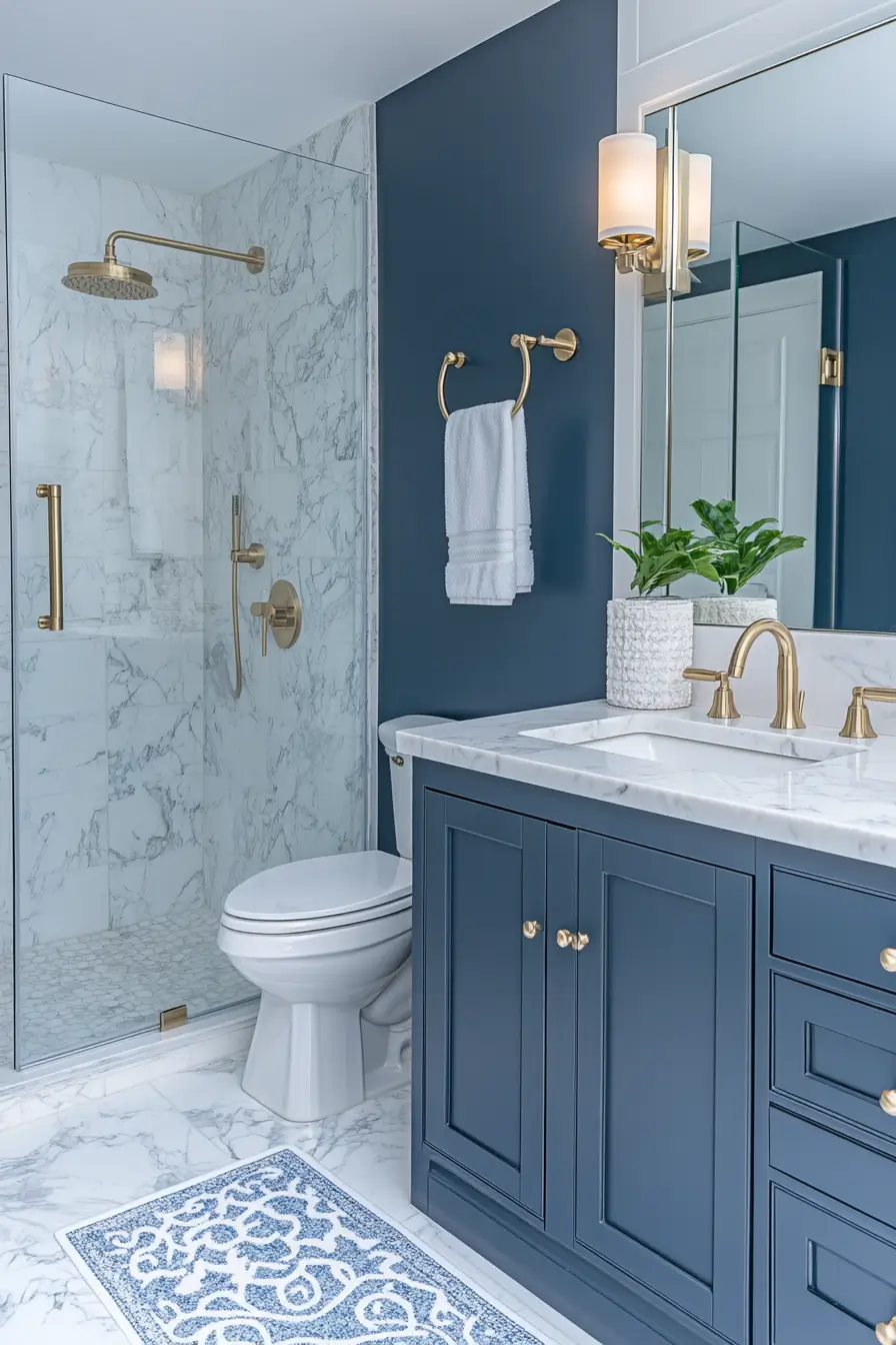 small master bathroom with a luxurious feel. Marble countertops, gold fixtures, and a glass walk-in shower